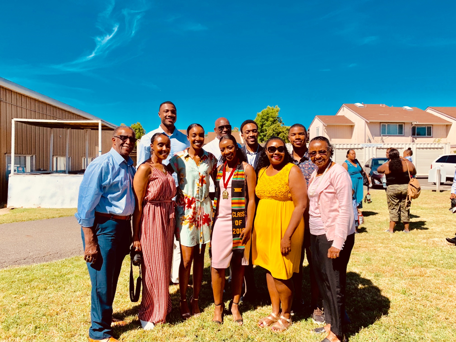 A scholar celebrating graduation surrounded by family
